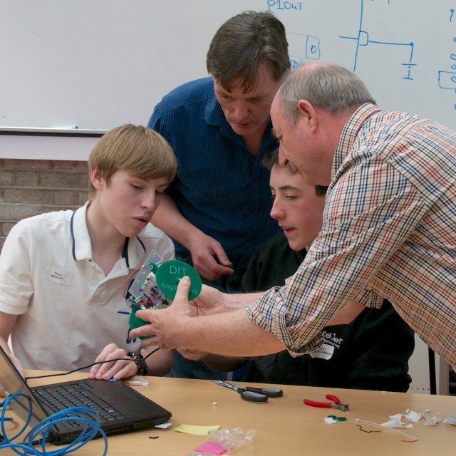 Engineering lecturers Frank Duignan and Mick Core explaining concepts to two Transition Year students at our May RoboSlam.