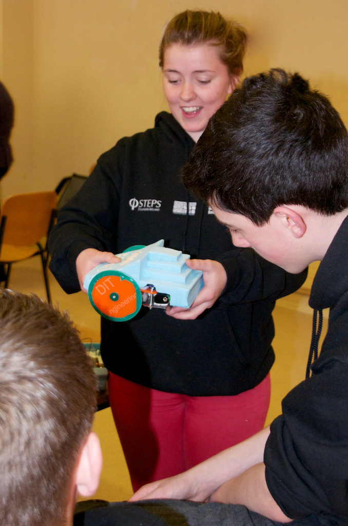 Transition Year students discussing their final, fully functioning robots.